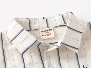 Close-up of kids striped shirt collar with resin button and premium fabric texture