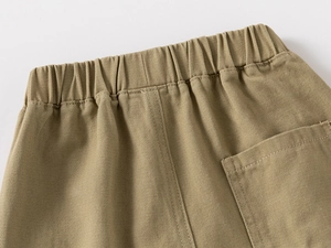 Detailed view of khaki cotton twill trousers with elastic waistband and back patch pocket