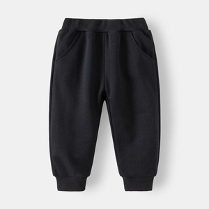 Detail of children's black jogger pants with elastic waistband and ribbed cuffs