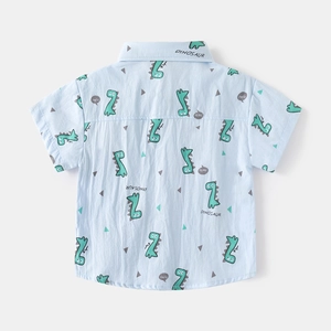 Detail of cotton kids short sleeve shirt featuring blue dinosaur print pattern