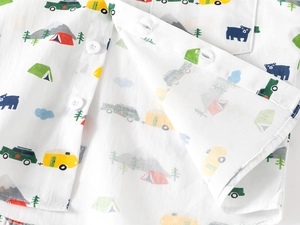 Close-up of kids camping print shirt showing white resin buttons and soft cotton texture
