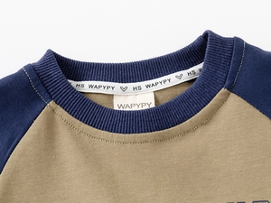 Detail of high-quality ribbed neckline and raglan contrast sleeves on children sweatshirt