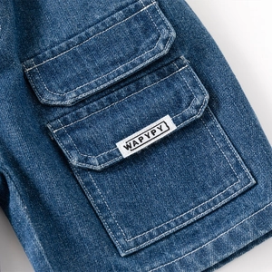Boy's denim shorts featuring a cargo flap pocket and stylish white woven brand label