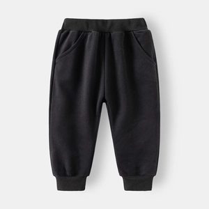 Detail of black kids' thick cotton sweatpants featuring elastic waist and ribbed cuffs