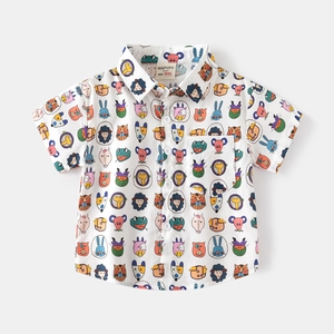 Flat lay of white short-sleeve boy's shirt with colorful cartoon animal print and pocket