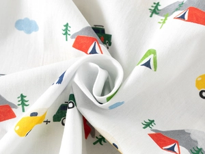 Detailed view of soft cotton fabric with colorful cartoon camping print and cars