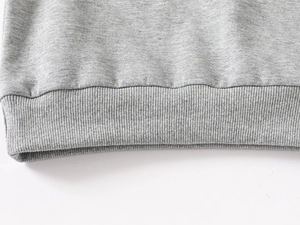 Macro view of heather grey cotton fabric texture and durable ribbed cuff stitching