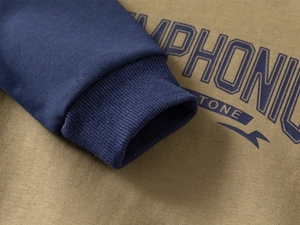 Detail of ribbed cuffs and letter print on khaki and navy kids sweatshirt set