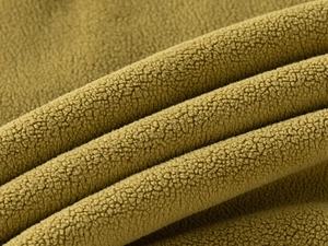 Detailed macro view of soft textured mustard yellow polar fleece fabric for kids set