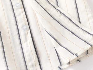 Close-up of striped cotton linen shirt featuring button placket and fine stitching details