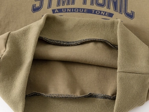 Detail of ribbed cuffs and soft fleece lining on olive green kids sweatshirt set