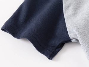 Detailed macro view of polo shirt sleeve with navy and grey pique fabric texture