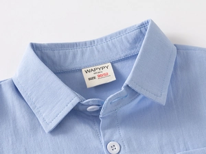 Macro shot of stylish blue cotton boys shirt collar with WAPYPY brand label and stitching