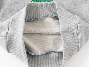 Detail view of grey sweatshirt ribbed cuff and soft loopback fabric lining