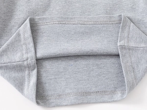 Detail of grey pique cotton fabric showing high-quality stitching and honeycomb texture