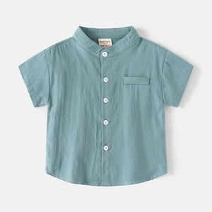 Detail of blue cotton linen kids short sleeve shirt with V-neck and wooden buttons