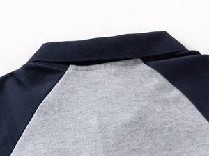 Macro detail of breathable pique cotton fabric and navy blue contrasting collar on polo shirt