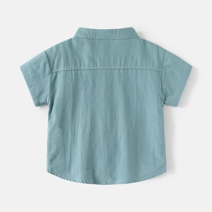 Detail view of cotton linen boys' short sleeve shirt showing fabric texture and back yoke