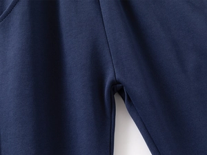 Close-up of durable flatlock stitching on navy blue children's trousers crotch detail
