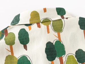 Detailed close-up of boys' shirt neckline showing high-quality stitching and tree print