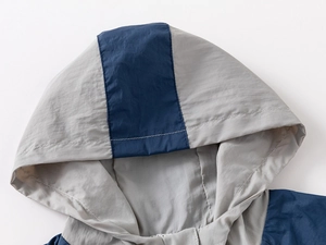 Detail of kids hooded sun protection jacket with navy blue contrast stitching and durable fabric
