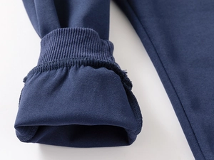 Close-up of premium navy blue ribbed knit cuffs with precise stitching on kids' sweatshirt