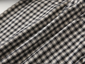 Close-up of black and white gingham cotton fabric showing detailed weave and soft texture