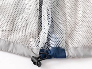 Detail of adjustable hem with mesh lining and drawstring toggle on kids outdoor jacket