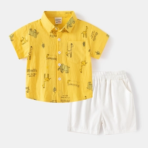 Toddler boys summer set with yellow giraffe print shirt and white shorts flat lay