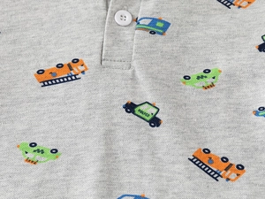 Detail of grey polo shirt featuring colorful cartoon car prints and cotton fabric texture