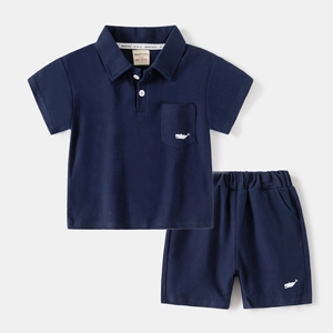Kids navy blue cotton polo shirt and shorts set with a minimalist white whale graphic