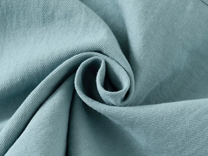 Macro view of light blue-gray fabric texture for boys' casual short-sleeve shirt