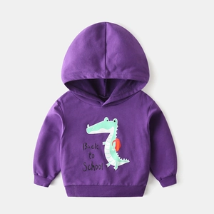 Close-up of a purple kid's hoodie with a cute green crocodile back-to-school print