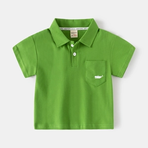 Detail of green cotton polo shirt featuring white whale embroidery on the chest pocket