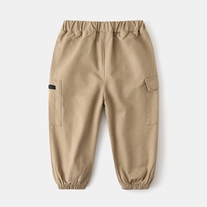 Detail of khaki cargo pants with elastic waist and stylish side pocket zipper for kids
