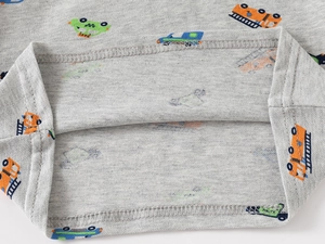Detail of grey knit t-shirt featuring colorful cartoon car prints and neat hem stitching