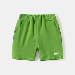 Detailed shot of kids bright green casual shorts with elastic waist and whale embroidery