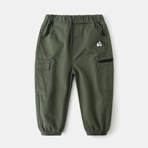 Detail of army green cargo pants featuring elastic waist and embroidered elephant pattern