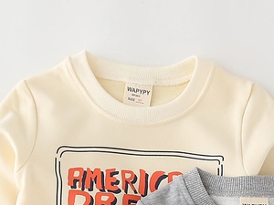 Detail of ribbed crew neck and printed logo on kids soft cotton sweatshirt