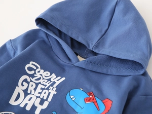Close-up of blue kids hoodie showing soft cotton fabric and cute dinosaur print