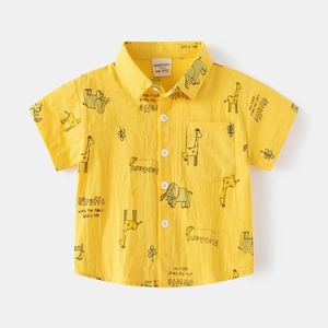 Detailed view of yellow boy's short sleeve shirt featuring cartoon giraffe and elephant prints
