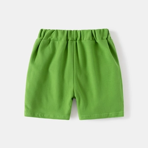 Detail of green cotton kids shorts with elastic waistband and high-quality stitching