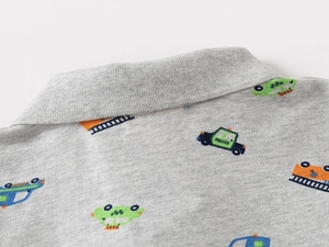 Close-up of kids pique cotton polo shirt featuring colorful cartoon vehicle prints