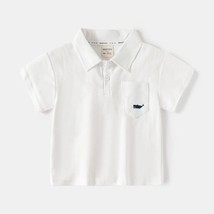 Close-up of kids white cotton Polo shirt featuring a small blue whale embroidery on the pocket