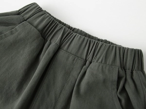Detail of elastic waistband and side pocket on boys dark gray cotton casual shorts