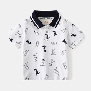 White cotton kids polo shirt with navy collar and cartoon dinosaur prints all over