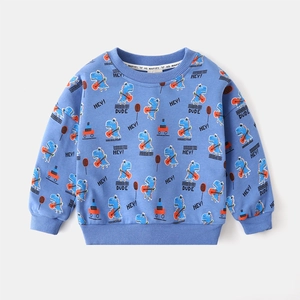 Close-up of blue dinosaur print on cotton toddler sweatshirt with soft fabric texture