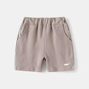 Detail of grey cotton shorts featuring elastic waist and white whale embroidery detail