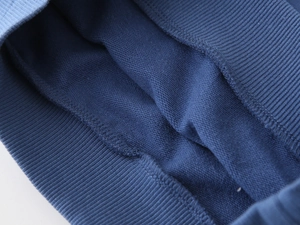 Detail of blue kids hoodie showing ribbed cuffs and soft fleece lining texture