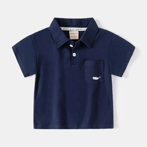 Detail of navy blue kids polo shirt featuring classic collar and embroidered whale pocket